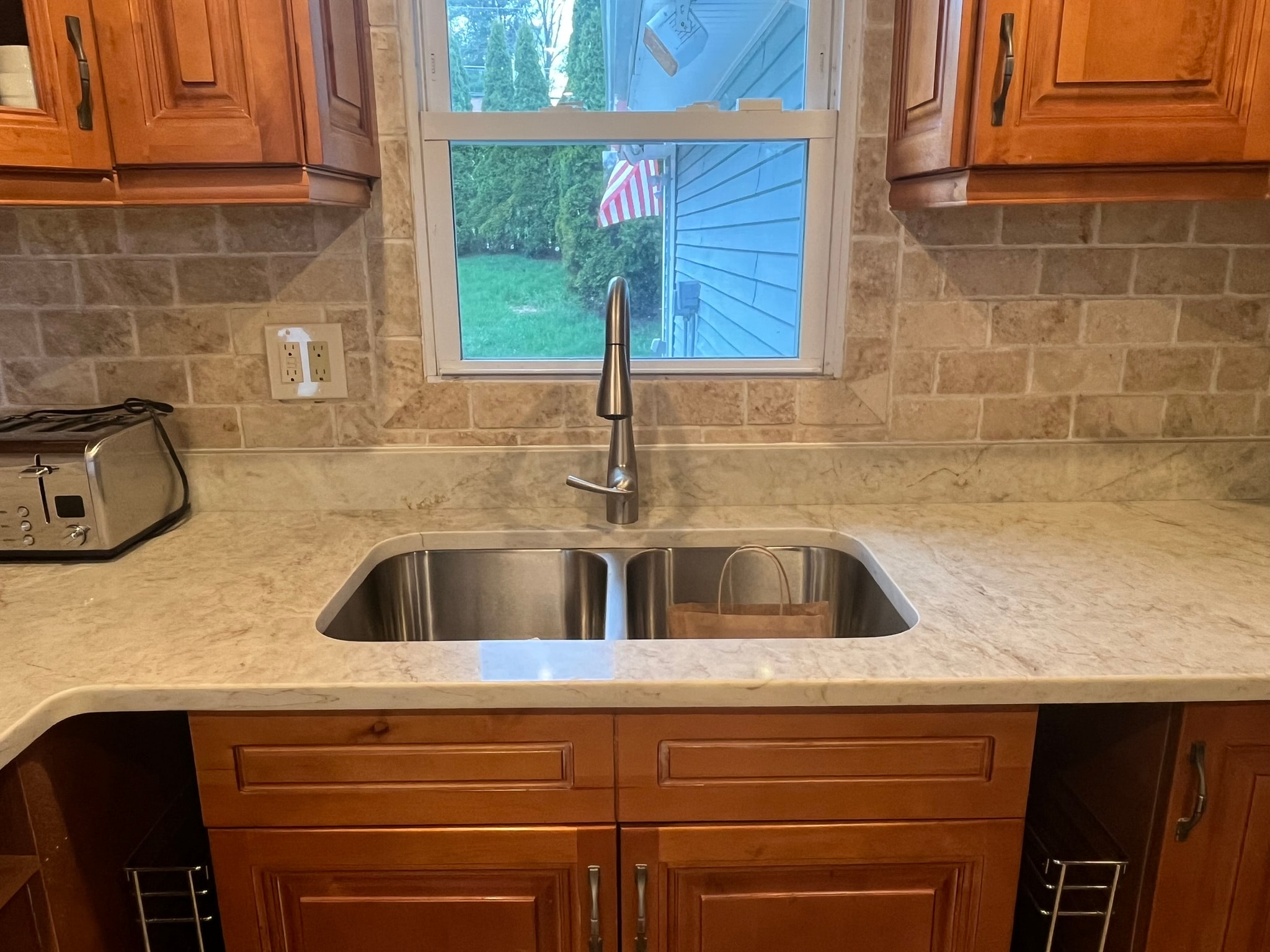 Gray kitchen with white quartz island countertop — wide view