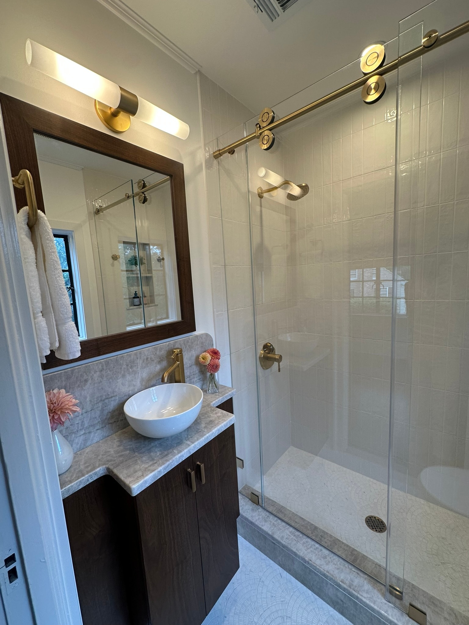 Bathroom with marble countertop and gold fixtures