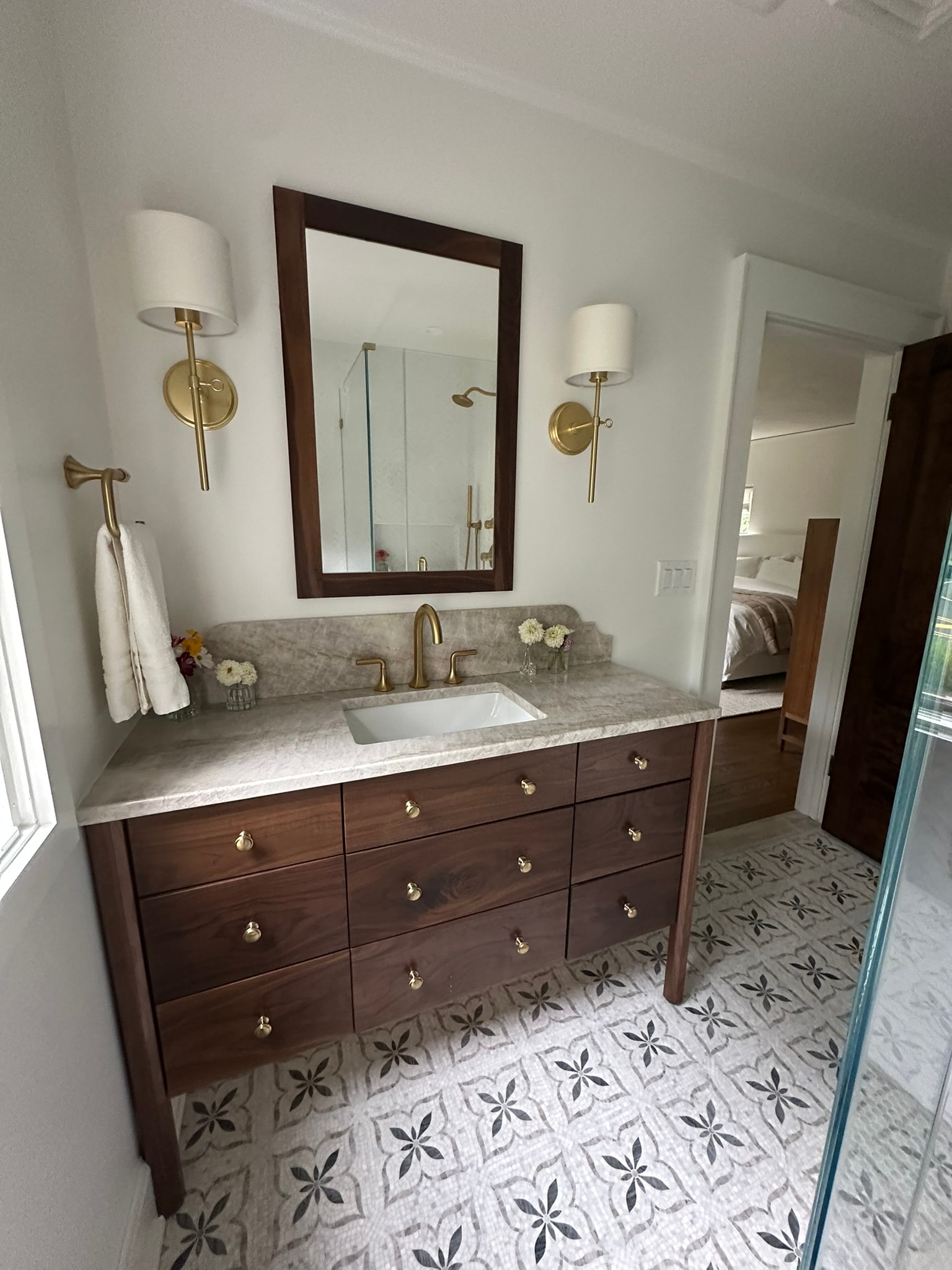 Bathroom vanity with marble countertop and gold fixtures